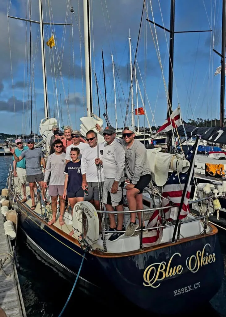 Blue Skies' crew poses together on deck at the dock after arrival