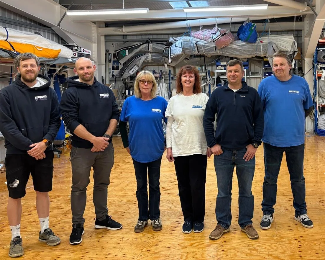 UK Sailmakers GBR South West team poses together inside their loft