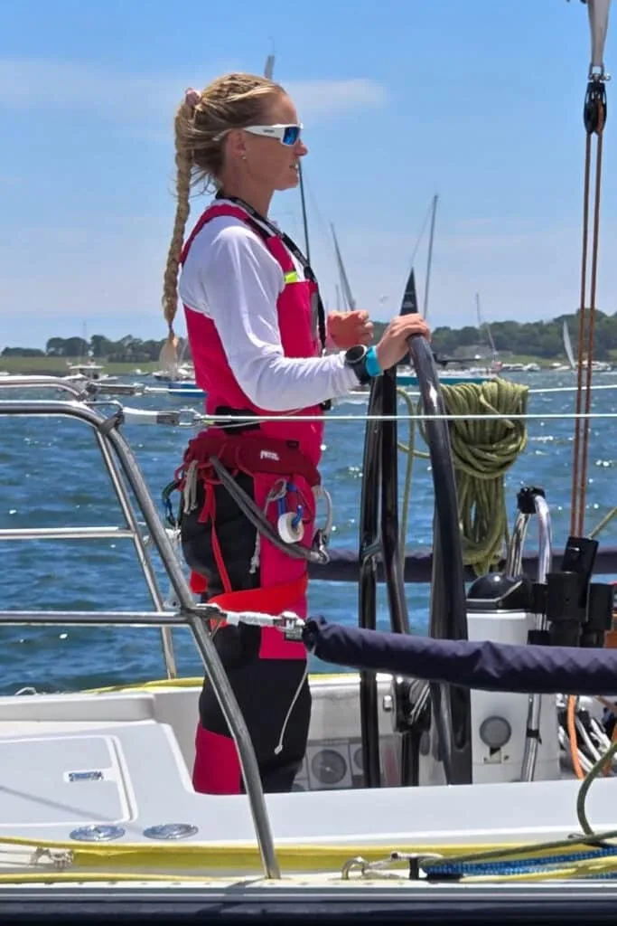 Crew member in red foul-weather gear stands on deck before the Bermuda Race start