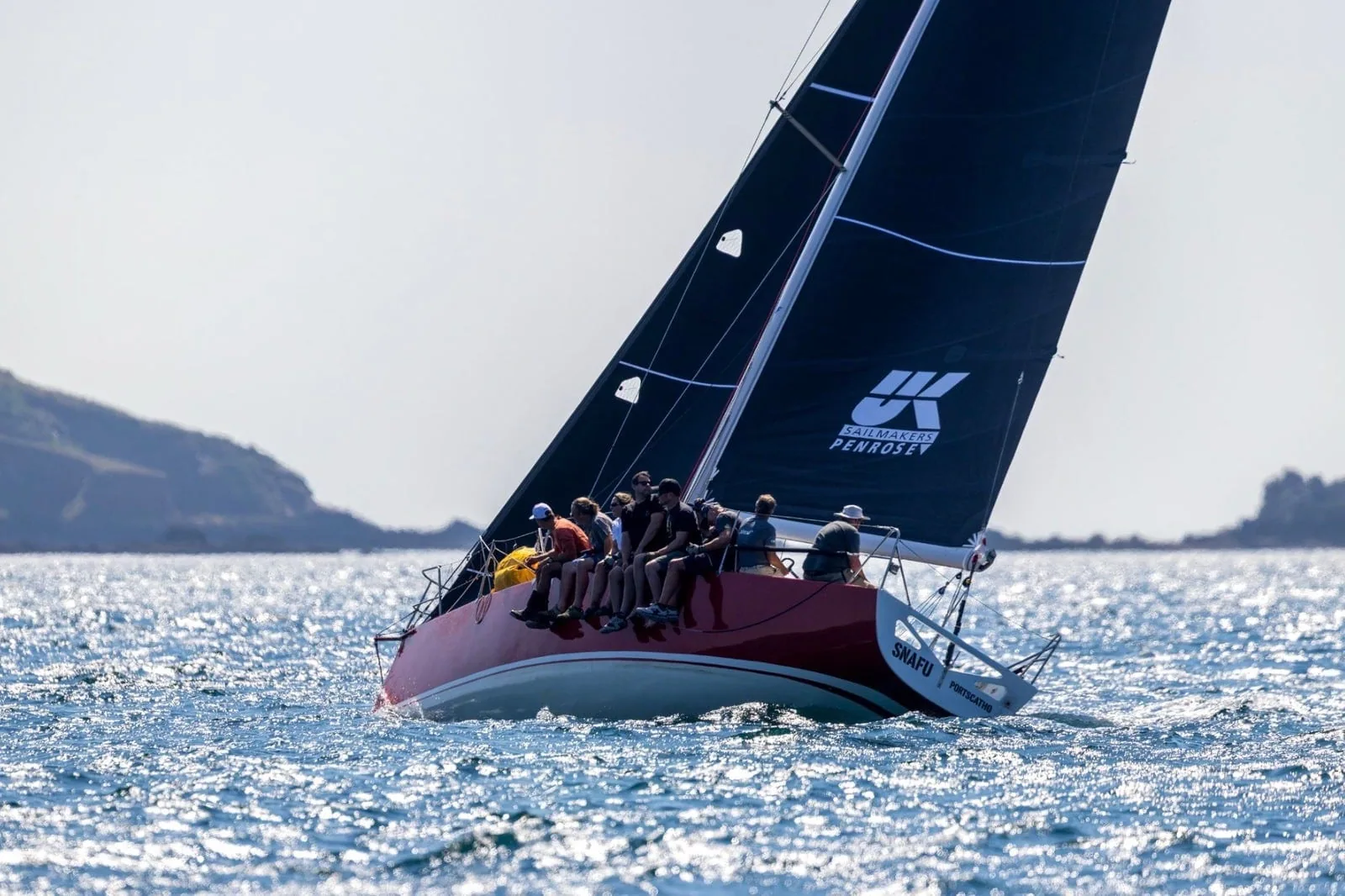 SNAFU's crew hikes out under a dark mainsail at Plymouth Race Week