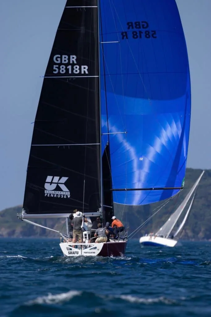 SNAFU flies a blue spinnaker beside her UK Sailmakers Penrose mainsail