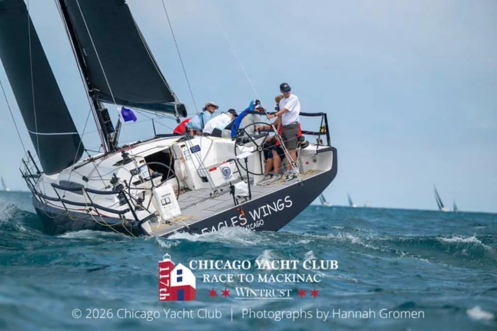 Eagles Wings heels on a close reach with crew grouped near the wheel