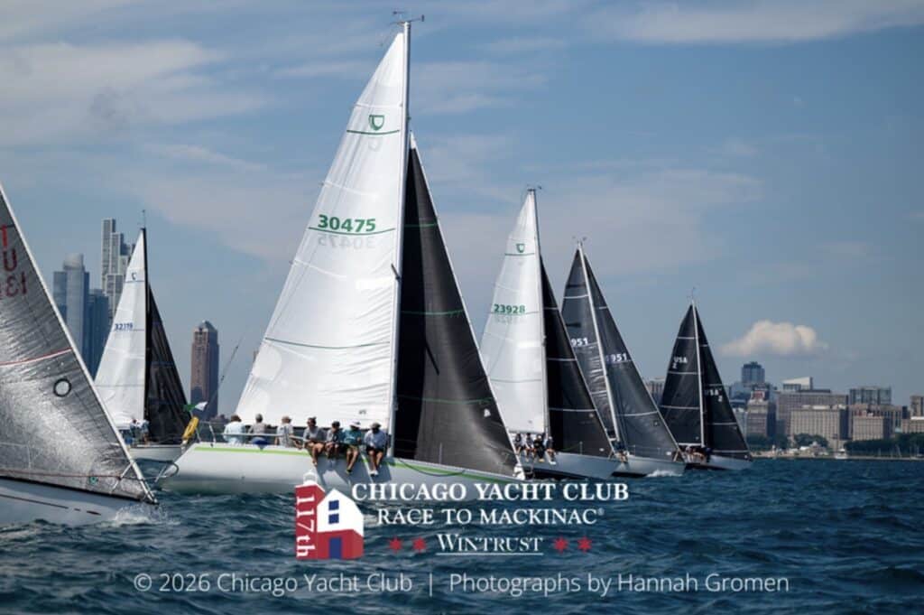 Fleet start off the Chicago skyline, sail Nos. 30475 and 23920 among the boats