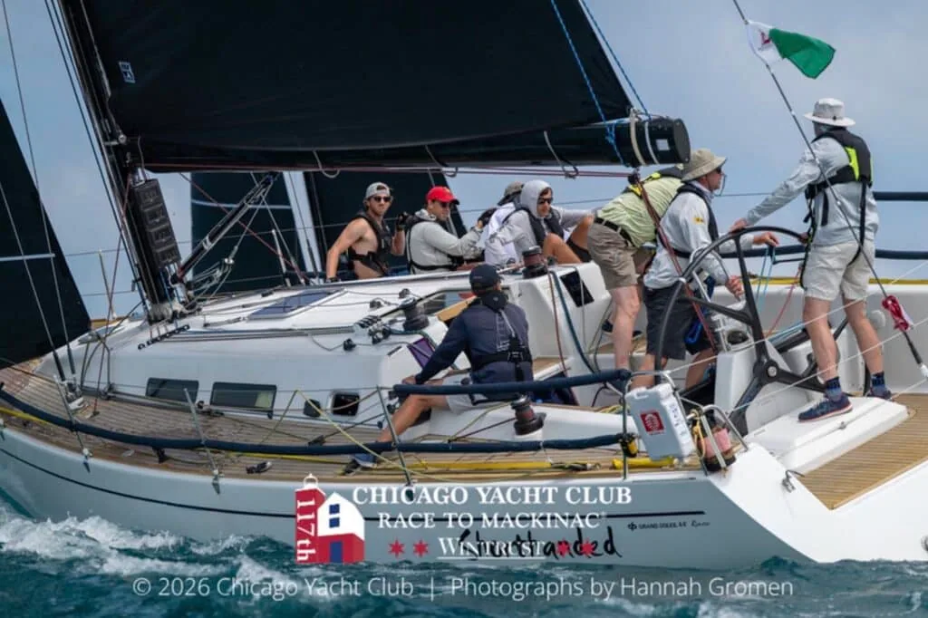 Crew tacks through a maneuver as the helmsman works the wheel