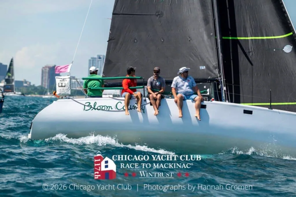 Bloom County heels under a dark mainsail as her crew hikes out