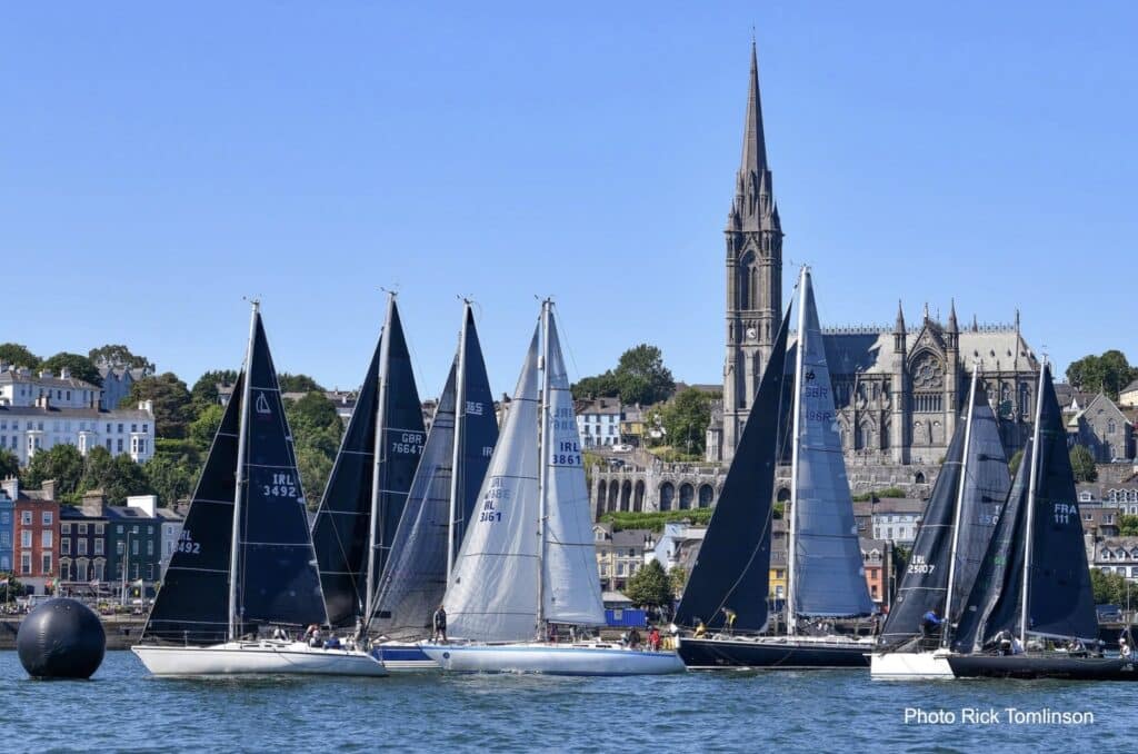Fleet races past Cobh's cathedral spire in Cork Harbour