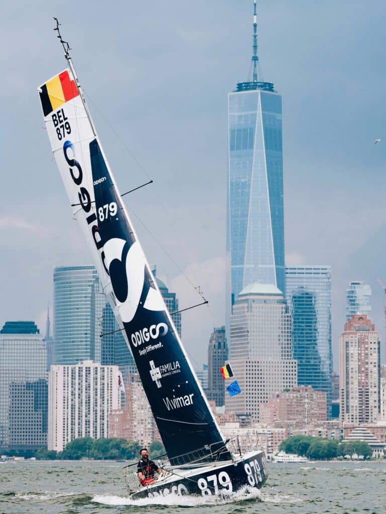 Quentin Debois sails Odigo, BEL 879, past Lower Manhattan and the WTC