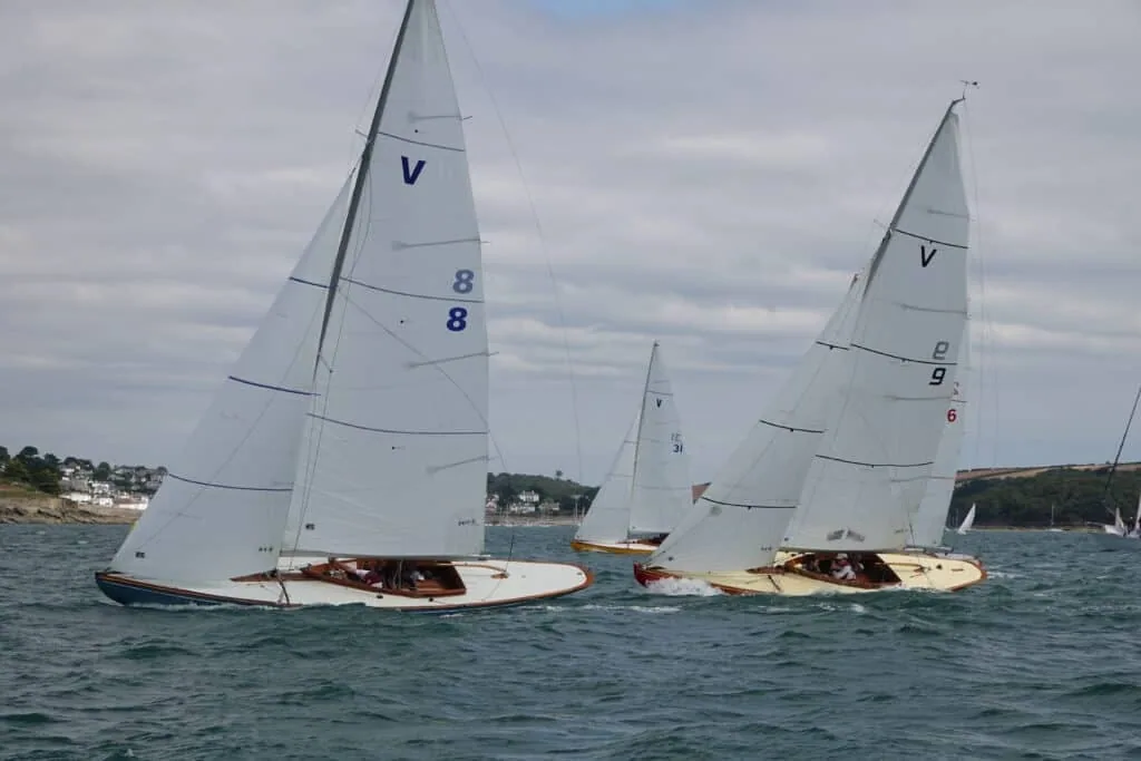 Two Sunbeam keelboats, V8 and V9, racing under white UK Sailmakers sails at Falmouth Week