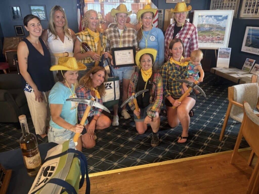 Karen Harris and the crew of Assarain IV collect their UK Sailmakers Northeast prize after winning the Traditional Non-Spinnaker Division.