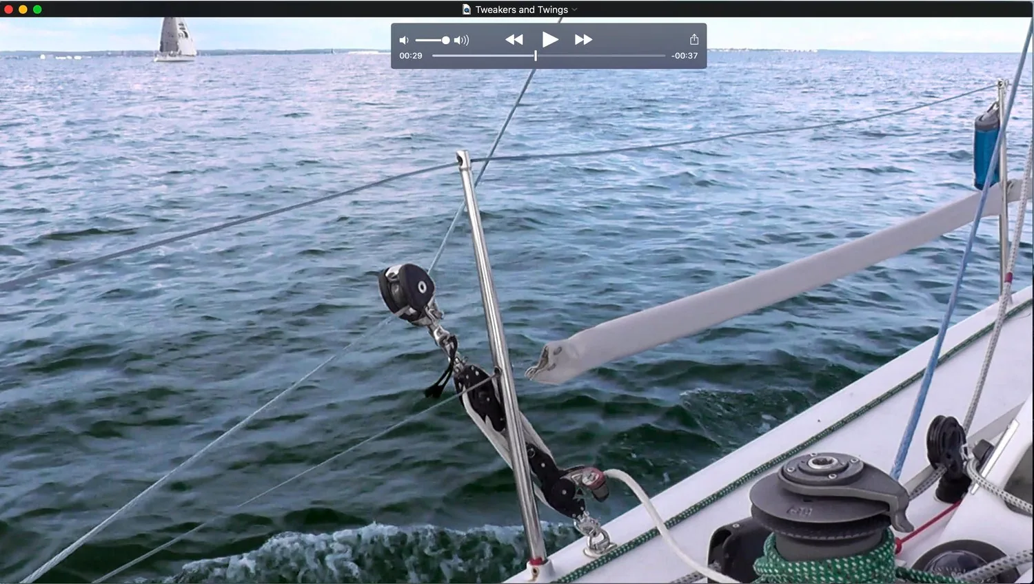 Video frame from 'Tweakers and Twings': a spinnaker sheet running through a twing block near the rail
