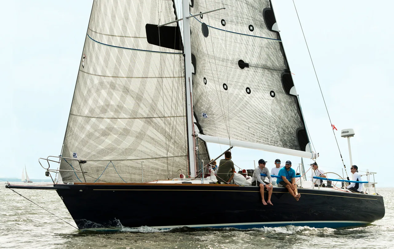 Dark-blue-hulled racer under grey laminate mainsail and genoa, crew on the rail, Vineyard Race overall winner