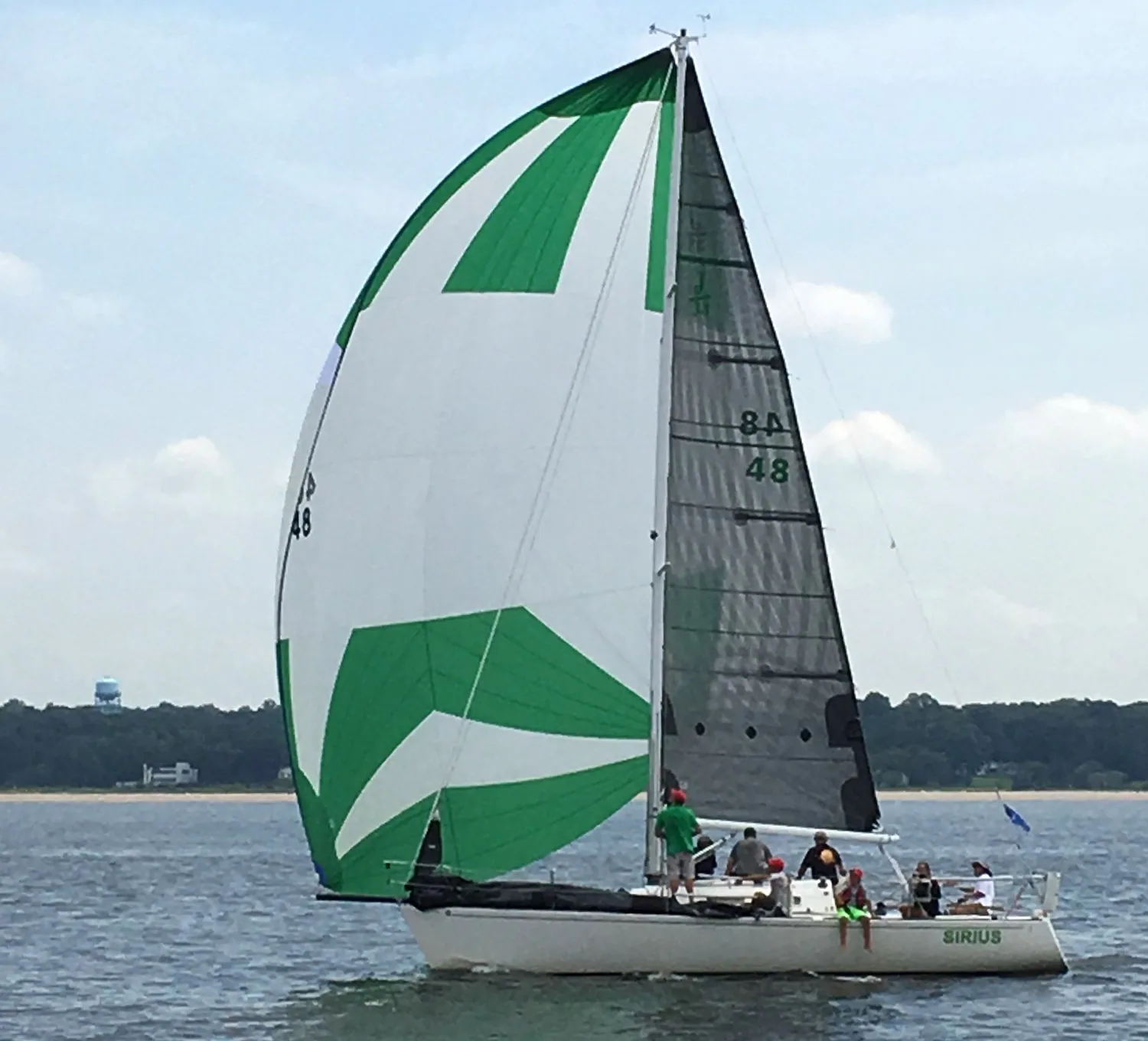 J/33 SIRIUS reaching under a green-and-white asymmetric spinnaker and black X-Drive® carbon mainsail, sail number 48