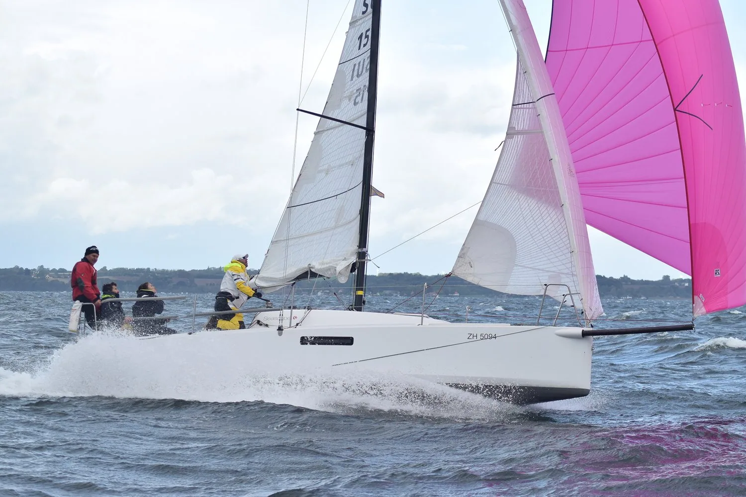Seascape 27 ESCAPADE planing under a reefed Tape-Drive Silver mainsail, jib and pink fractional asymmetric spinnaker