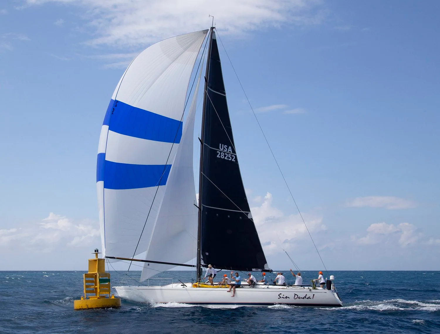Santa Cruz 52 SIN DUDA!, USA 28252, finishing off Montego Bay under a black mainsail and blue-banded white spinnaker
