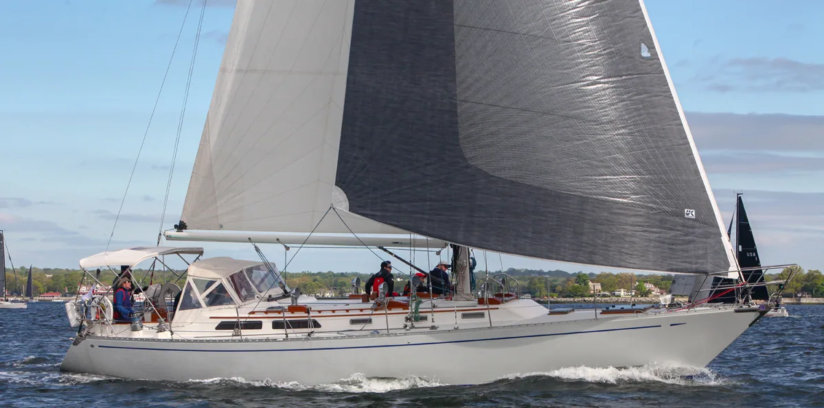 Alden 50 ELENA sailing under a new grey X-Drive® genoa and white mainsail, crew gathered under the dodger