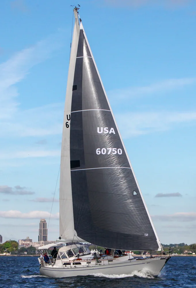 Alden 50 ELENA's dark grey X-Drive® genoa with sail number USA 60750 set against a blue sky and city skyline