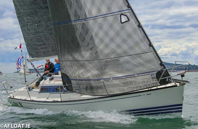 X-302 DUX beating upwind under grey X-Drive® mainsail and No. 1 genoa, two crew in the cockpit, blue-striped hull