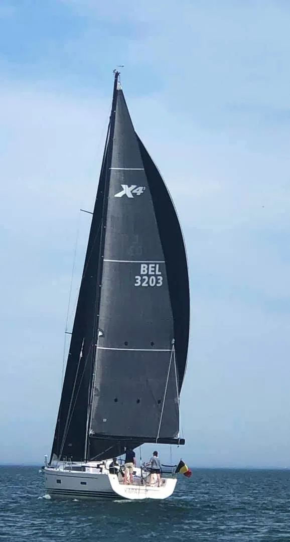 X-Yachts X4³ BEL 3203 sailing under a dark Code D and black X-Drive® mainsail with a Belgian flag at the stern