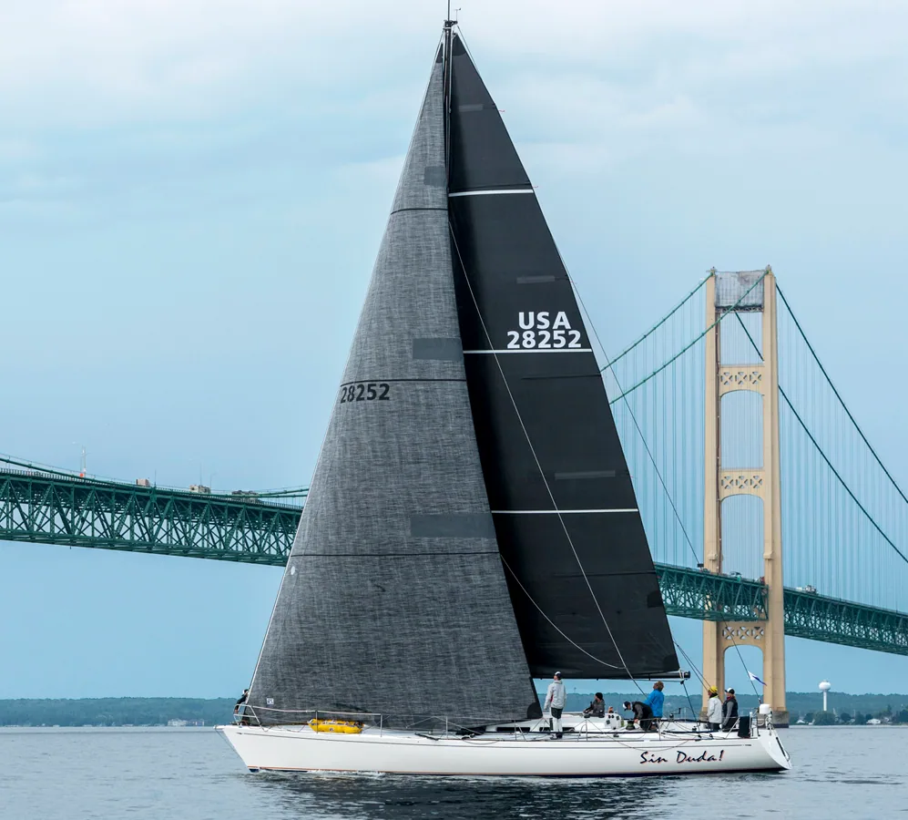 Santa Cruz 52 SIN DUDA!, USA 28252, ghosting under the Mackinac Bridge with dark grey mainsail and jib