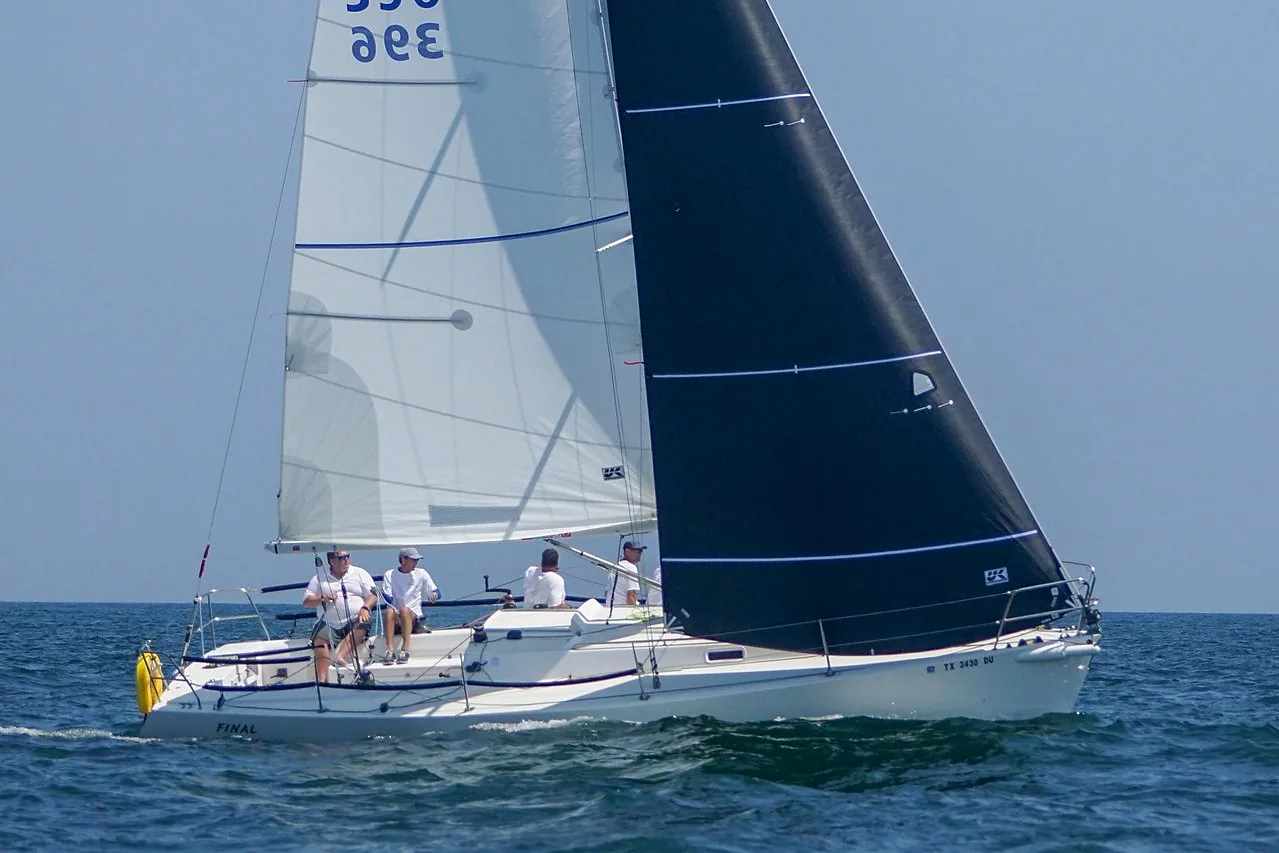 Ken Horne's J/105 FINAL FINAL beating upwind with white UK Titanium class jib and dark mainsail, crew in white shirts