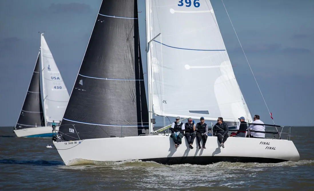 J/105 FINAL FINAL, 396, upwind with black mainsail and white jib, five crew on the rail, another J/105 astern