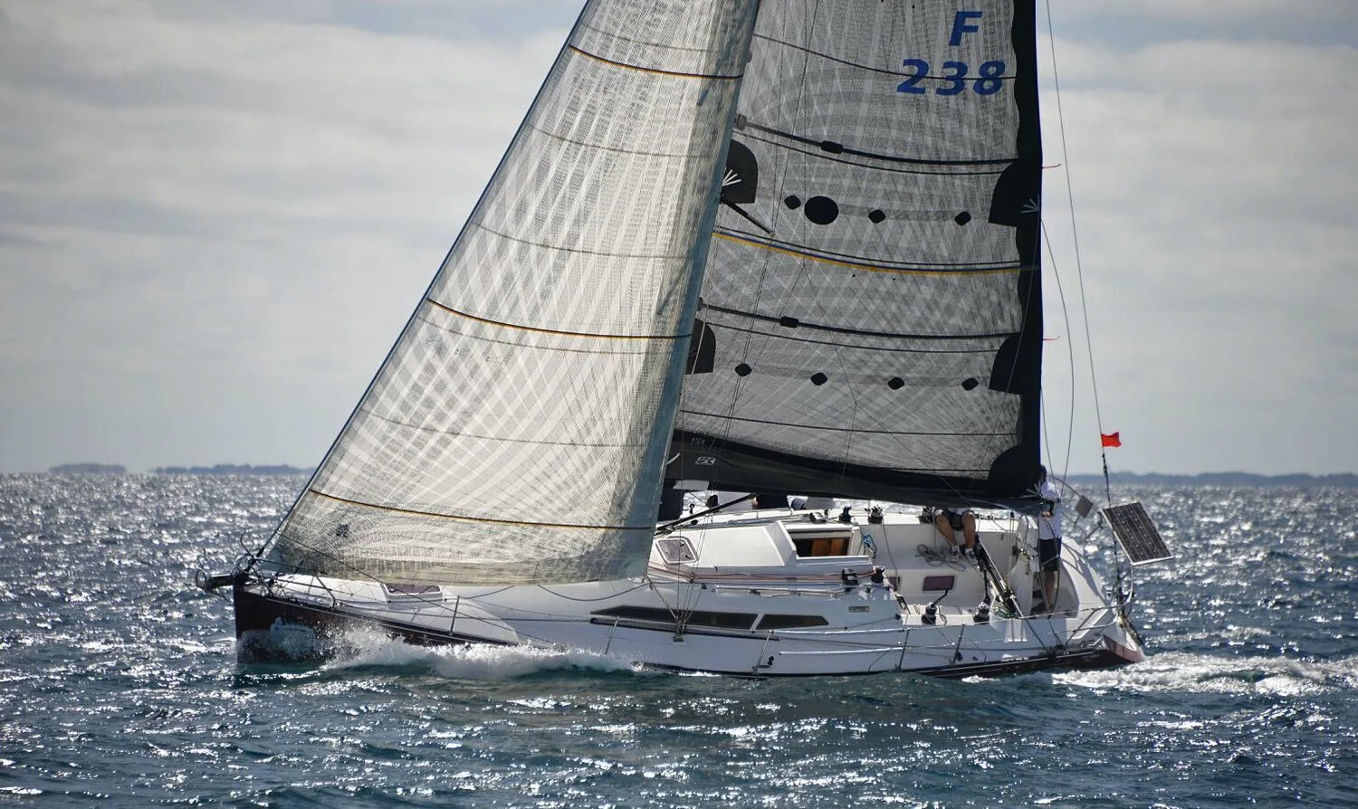 C&C 115 CRO CONNECTION sailing upwind under a grey laminate genoa and black mainsail in choppy seas
