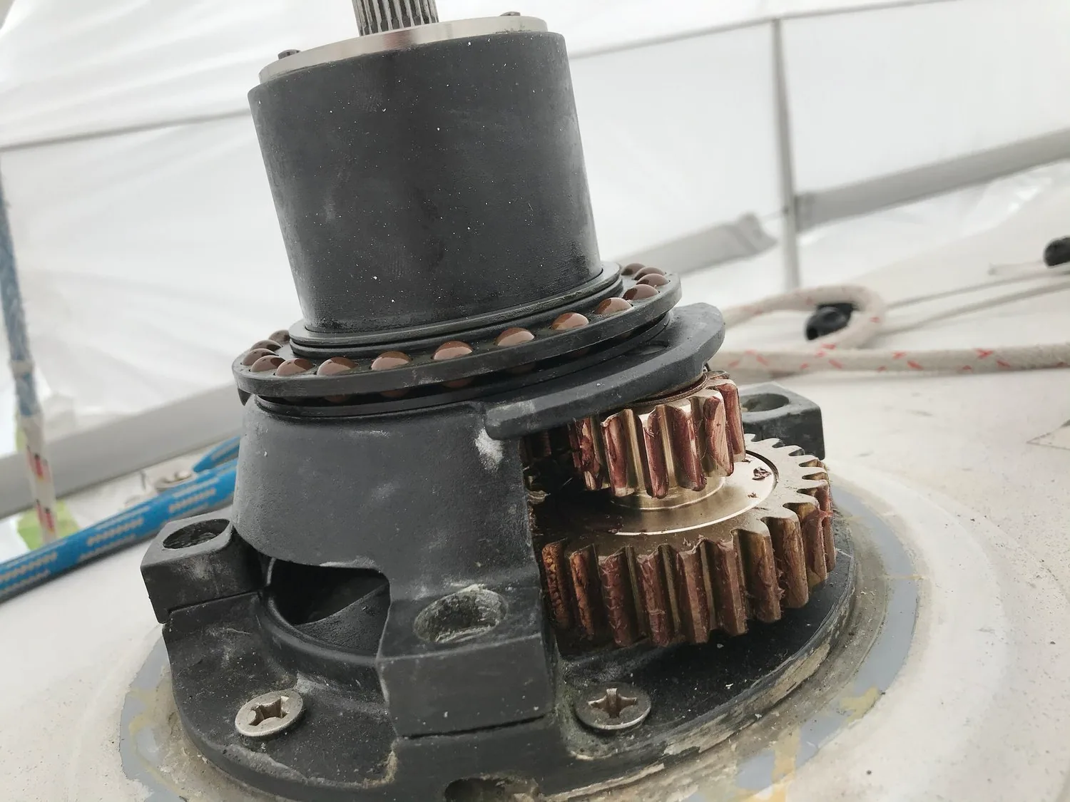 Winch with the drum removed, exposing bronze gears, a roller bearing and the central spindle on deck