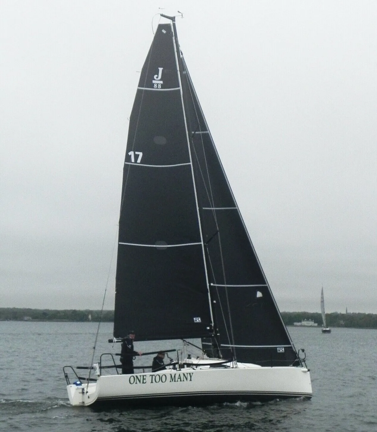Andrew Weiss and Lawrence Cutler's J/88 One Too Many under black sails, number 17, sailing before the start