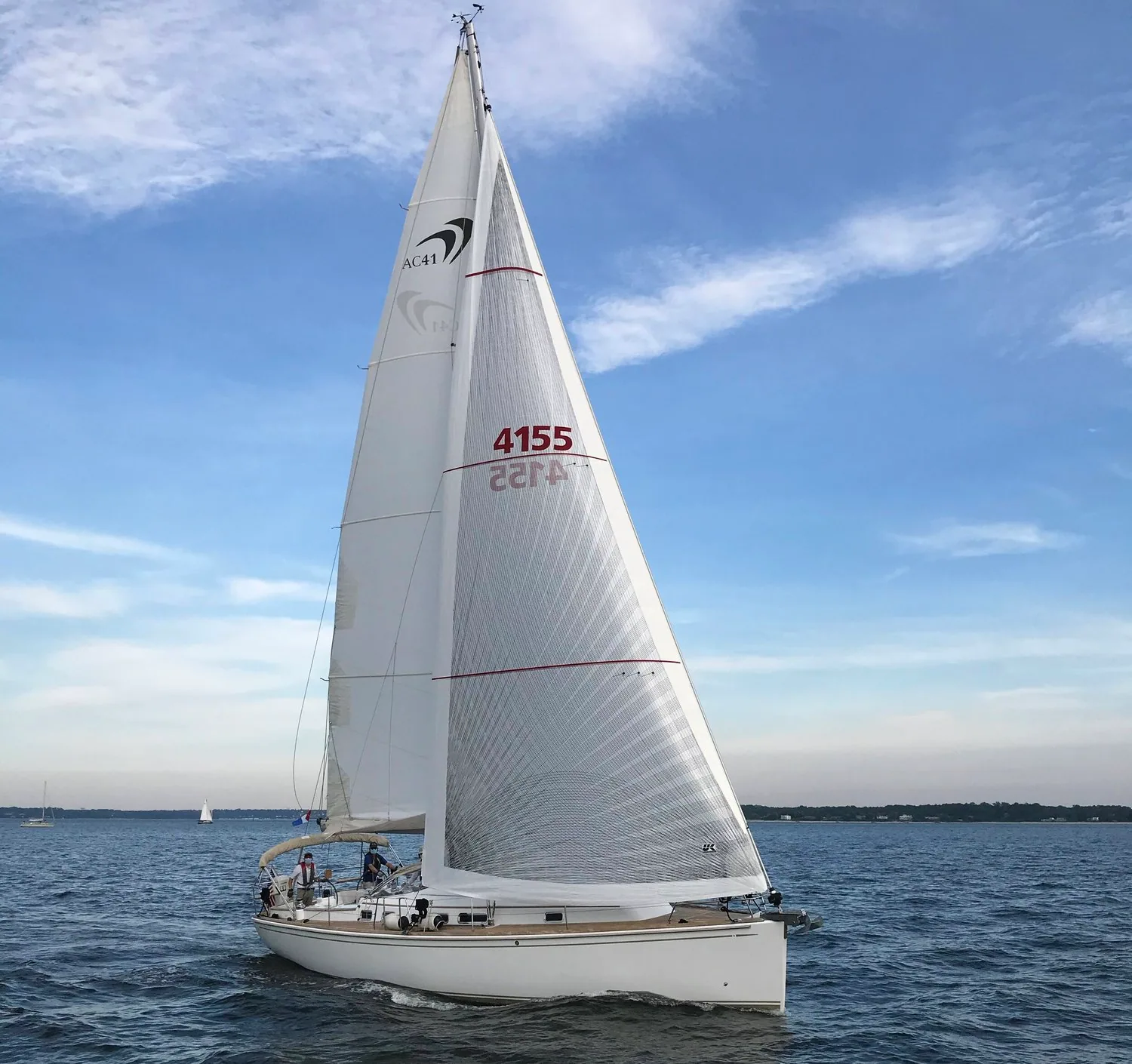 Sloop sailing under white X-Drive® main and genoa, sail number 4155 with red draft stripes, in a light breeze