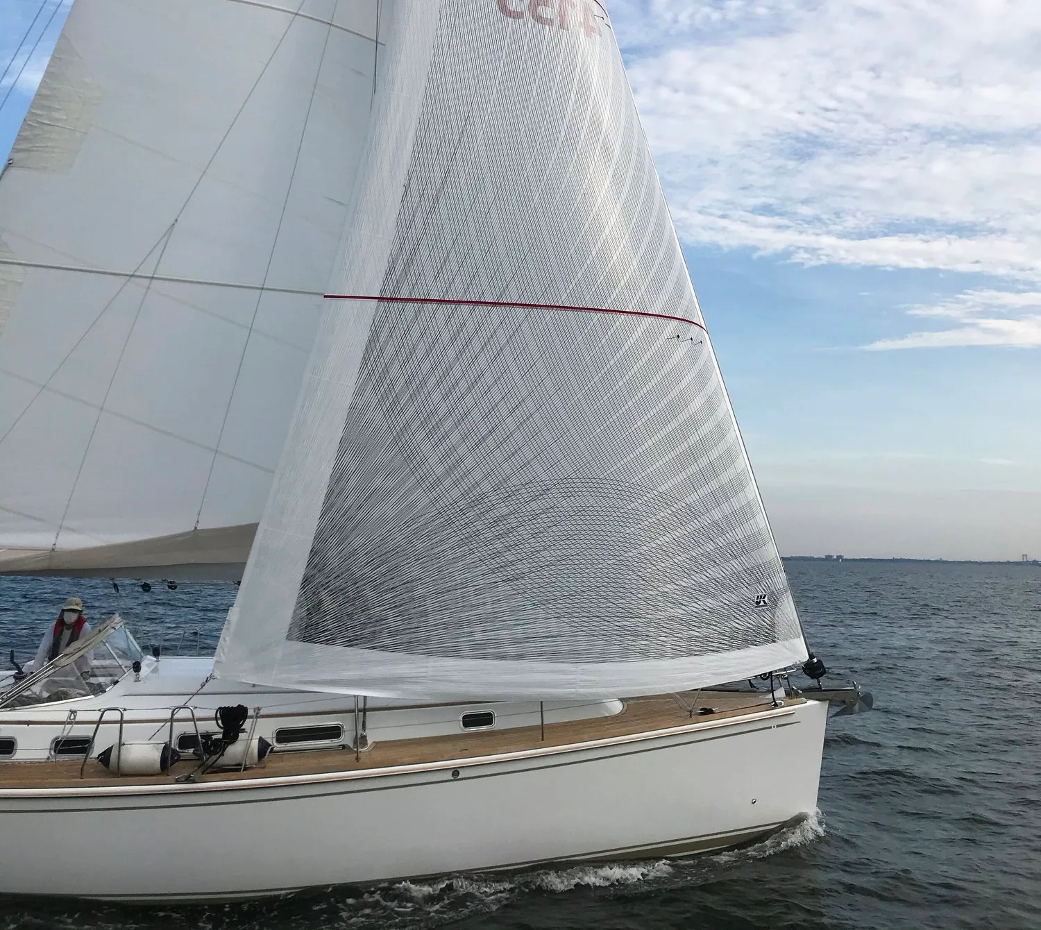 X-Drive® genoa close up showing the diagonal fibre tapes and a red draft stripe, teak side deck below