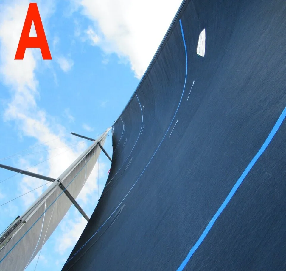 Photo A: looking up the luff of a dark navy jib with blue draft stripes beside the mast and spreaders