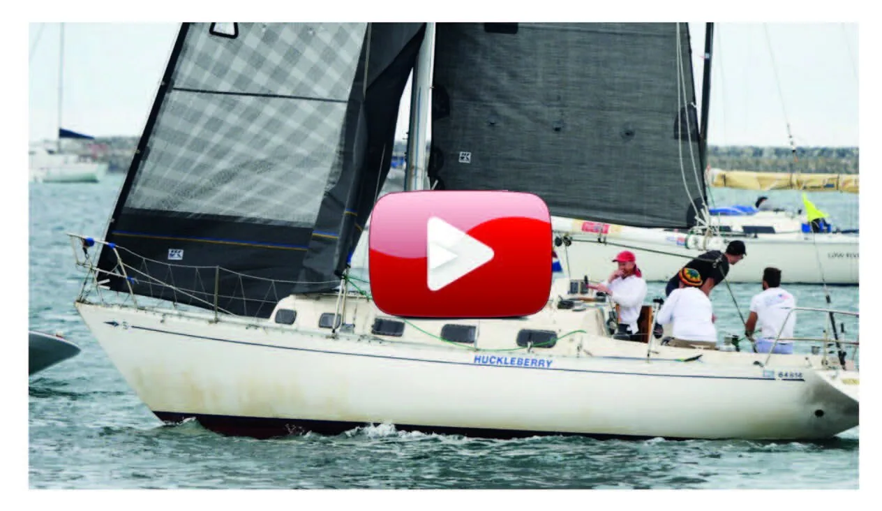 Video thumbnail: white sloop HUCKLEBERRY under grey X-Drive® mainsail and genoa with crew aboard, red play button overlay