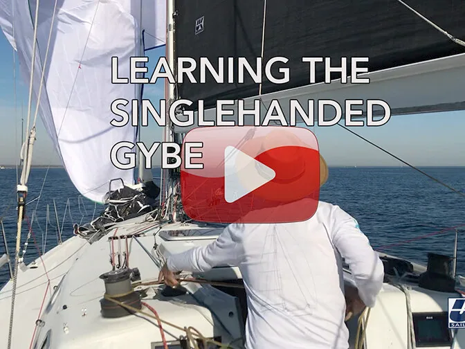 Video thumbnail titled Learning the Singlehanded Gybe: helmsman in a white shirt with a white spinnaker set, play button