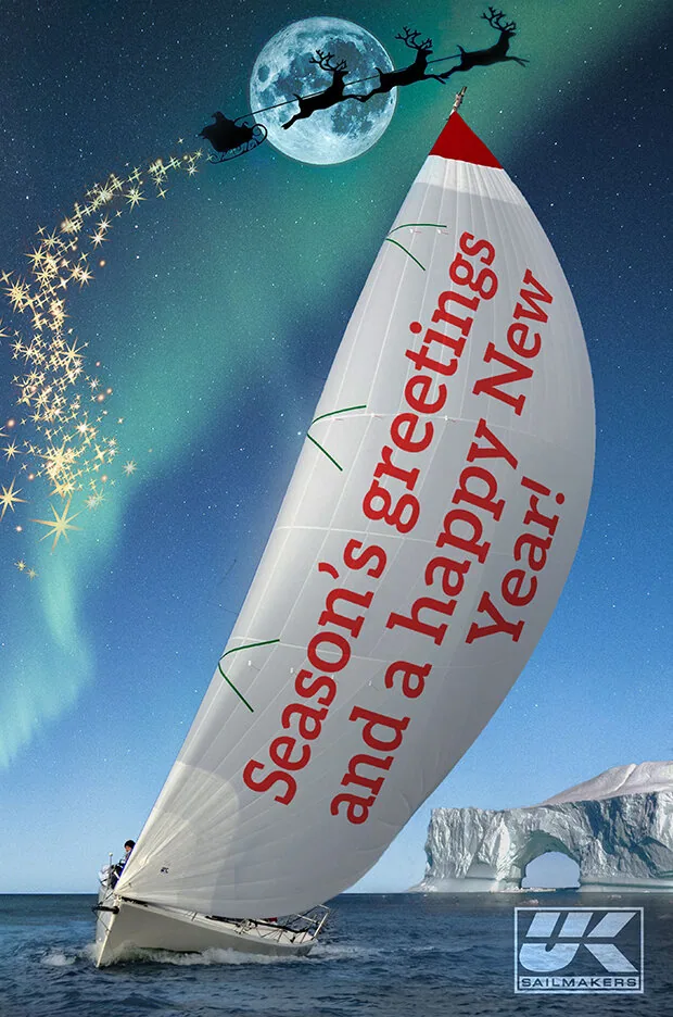 Holiday graphic: spinnaker lettered 'Season's greetings and a happy New Year!' under Santa's sleigh and a full moon