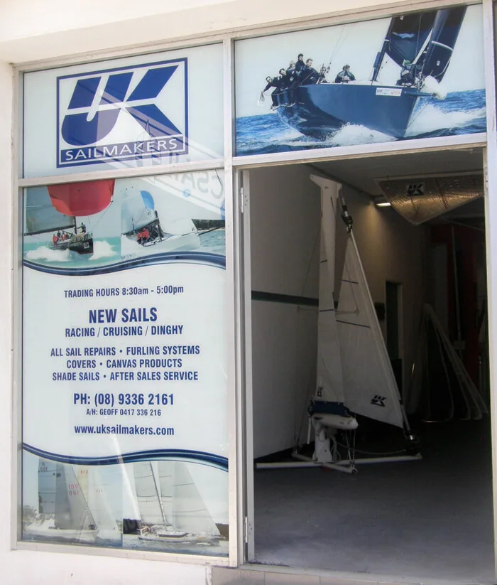 UK Sailmakers loft shopfront in Western Australia: window graphics with logo, services and phone number, sail inside the door