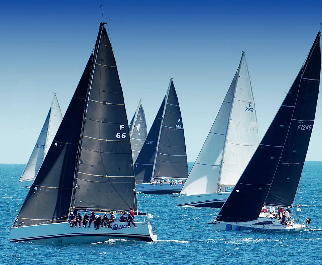 King 40 CHECKMATE (F 66) under black sails leading a fleet including F 752 and F1245 after the Bunbury and Return start