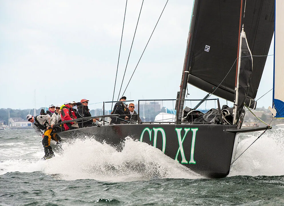 Fast 40+ Christopher Dragon, black hull lettered CD XI, throwing spray with crew on the rail under a black Titanium mainsail