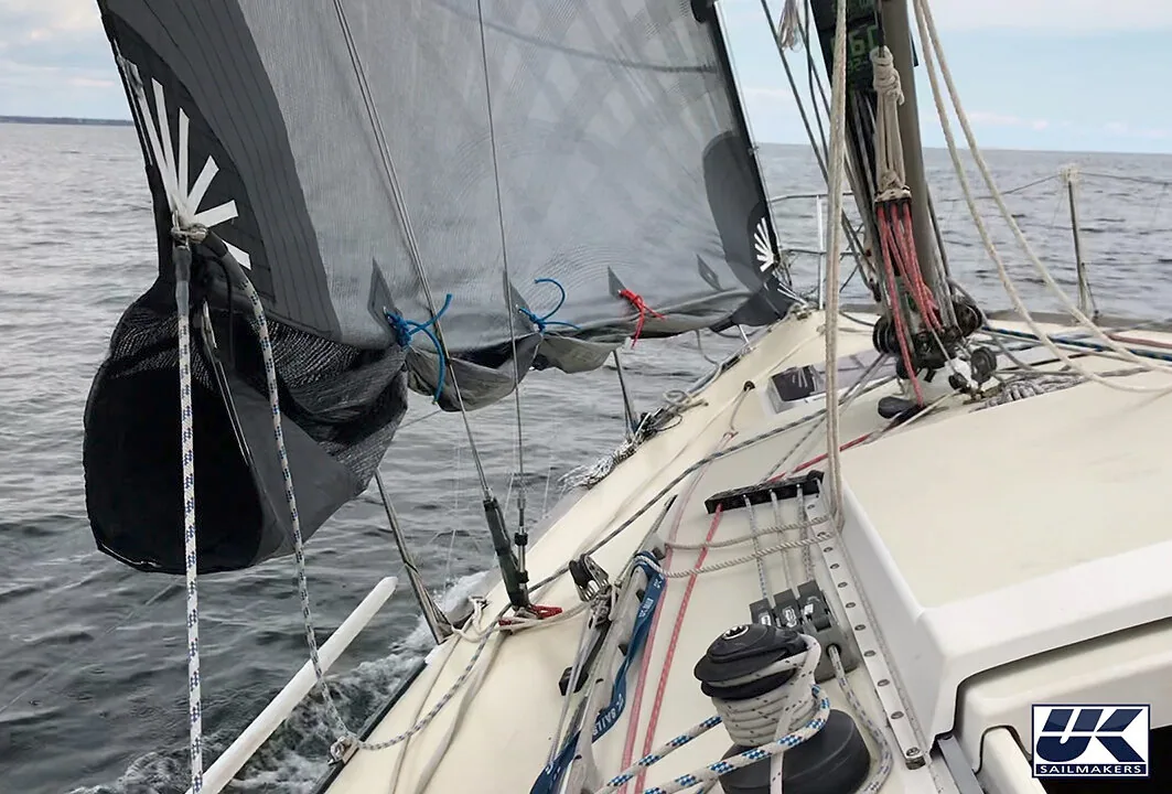 Above: The reefed part of the sail is shown tied up. Below: The reefed part is rolled and then zipped away with an integral zipper system.