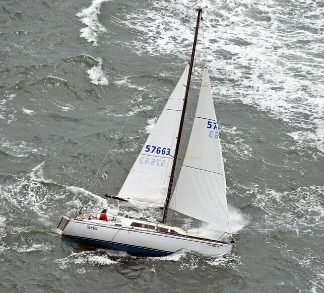 Aerial view of Siren, sail 57663, sailing reefed through choppy grey water at the start of the Singlehanded Transpac